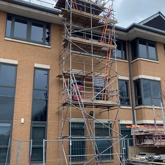 small scaffolding on a large building